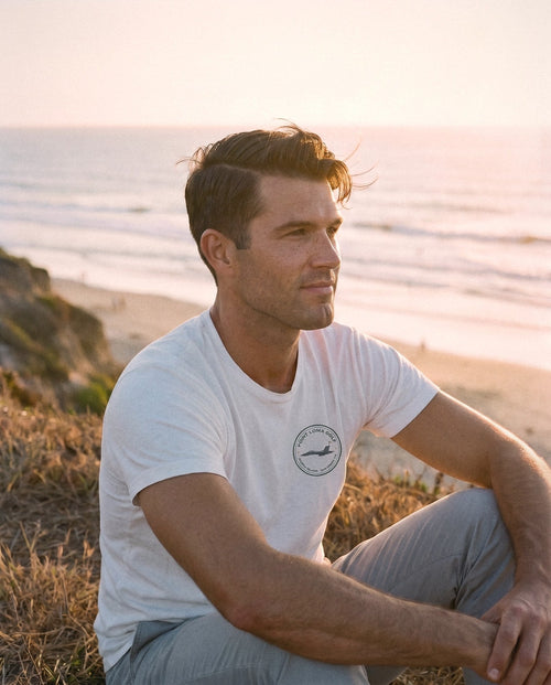 White North Island tee on the bluff at sunset