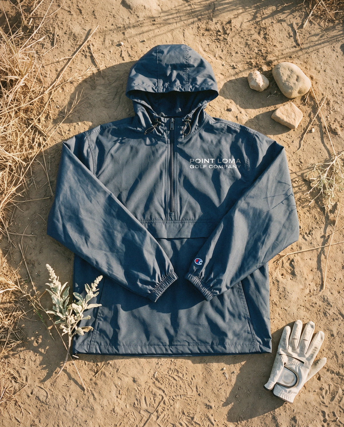 Navy windbreaker flat lay with the Point Loma Golf Company lockup