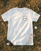 White tee flat lay with the North Island patch