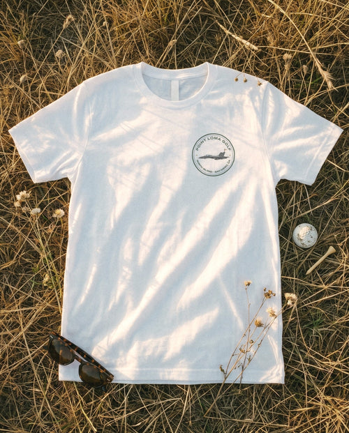 White tee flat lay with the North Island patch