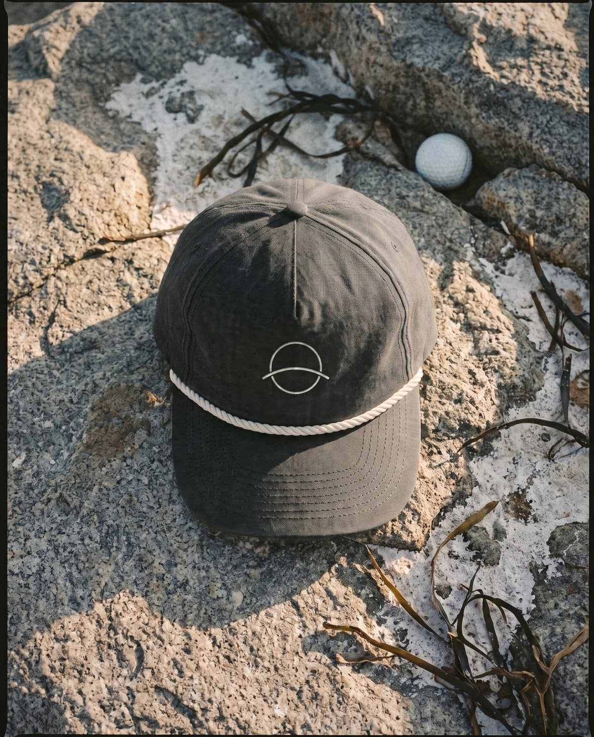 Black rope cap with the white mono mark