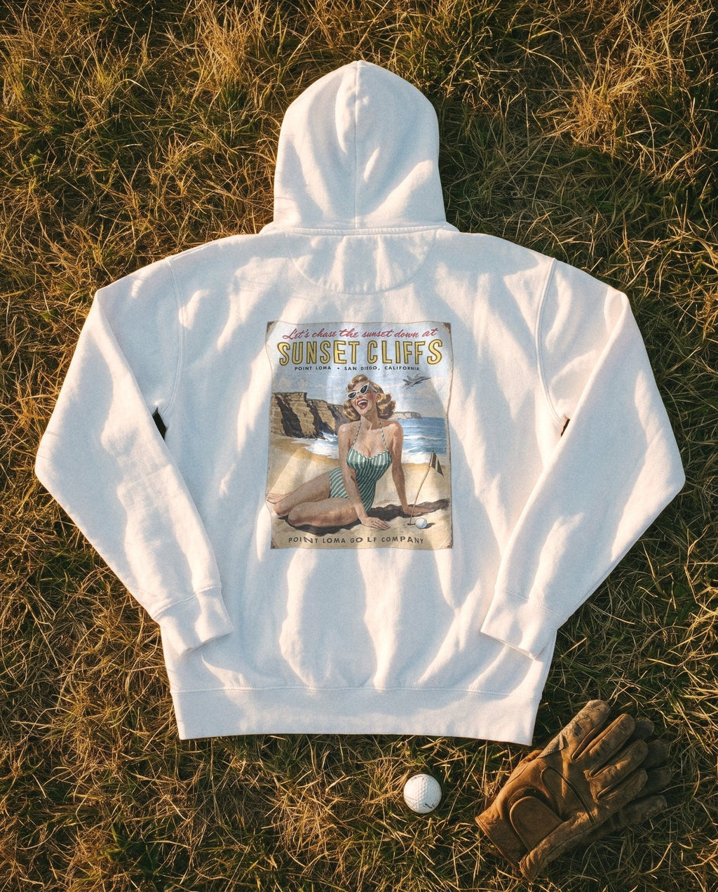 White Flyover Hoodie flat lay, Sunset Cliffs sunset sign on the back