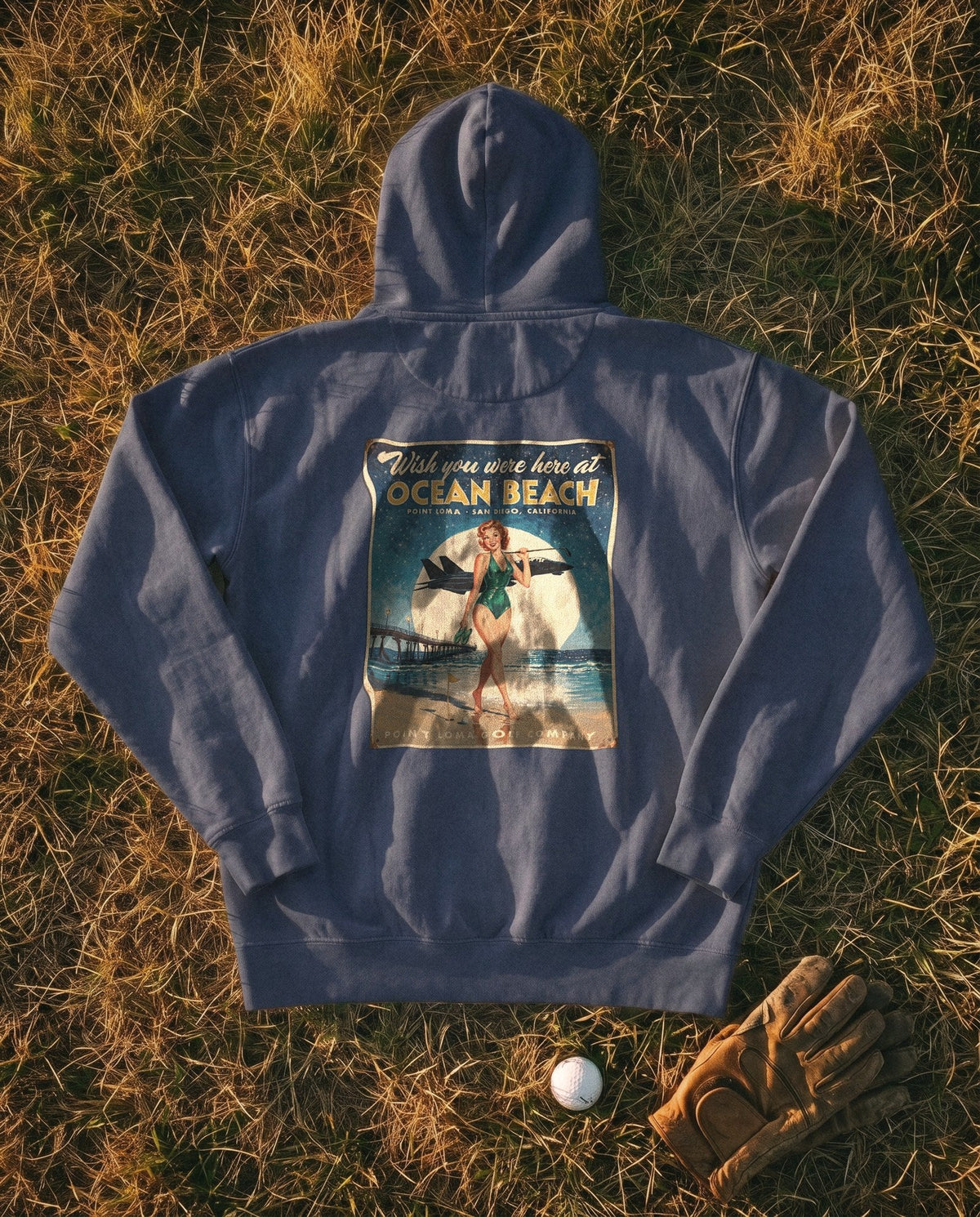 True Navy Flyover Hoodie flat lay, Ocean Beach sign on the back