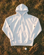 White Flyover Hoodie flat lay, forest mono mark on the chest