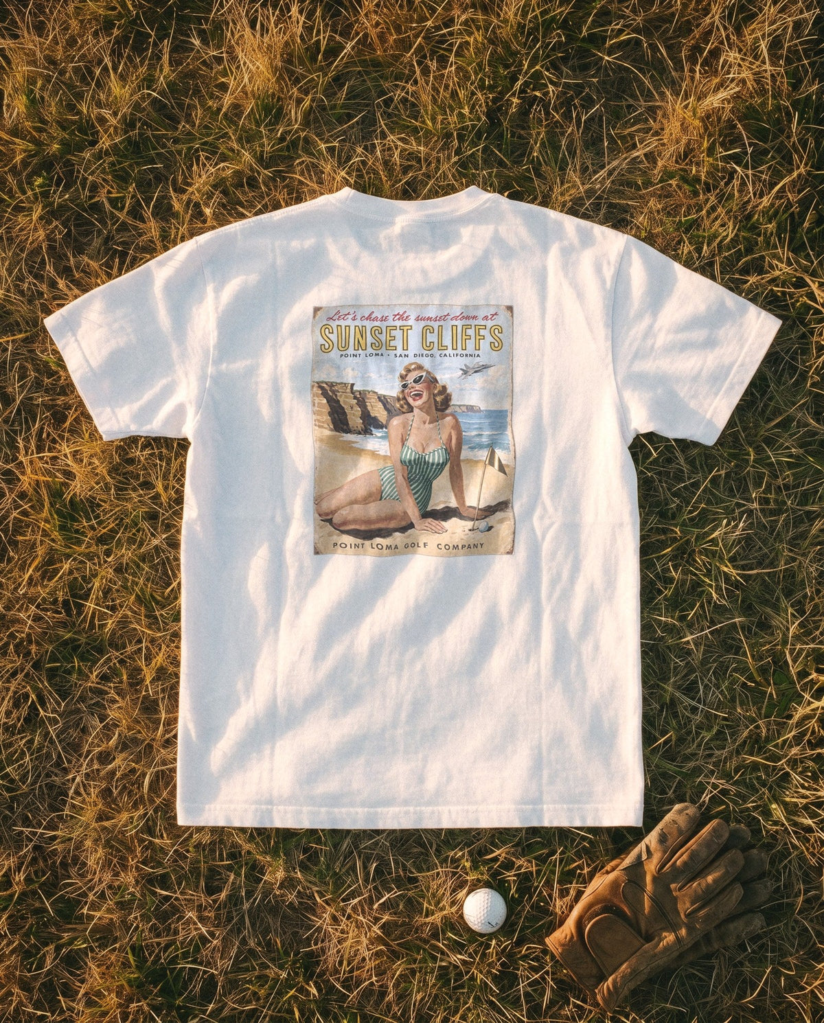White Flyover Tee flat lay, Sunset Cliffs sunset sign on the back