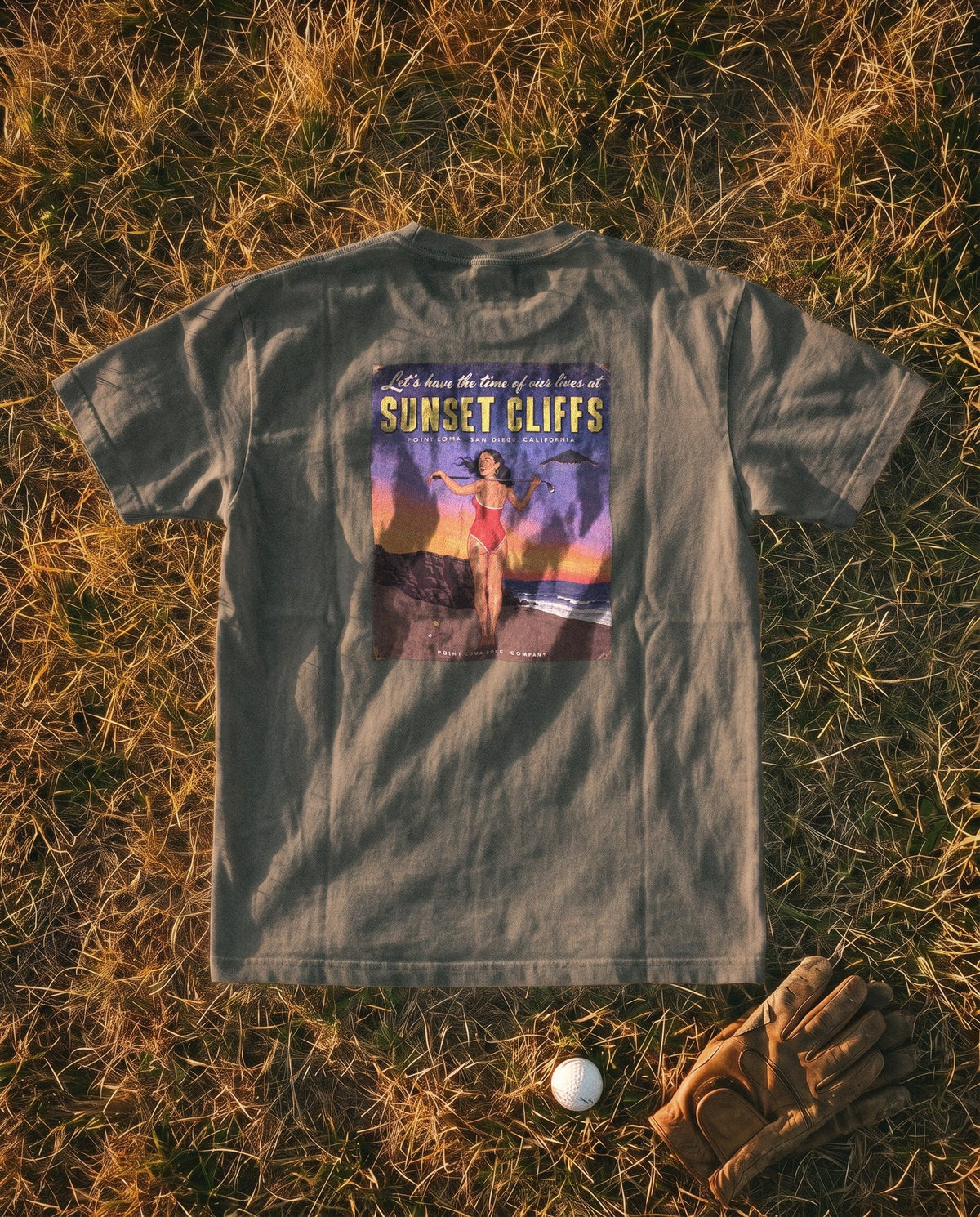 Pepper Flyover Tee flat lay, Sunset Cliffs dusk sign on the back