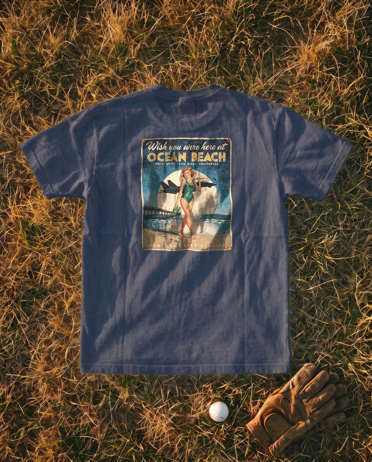 True Navy Flyover Tee flat lay, Ocean Beach sign on the back